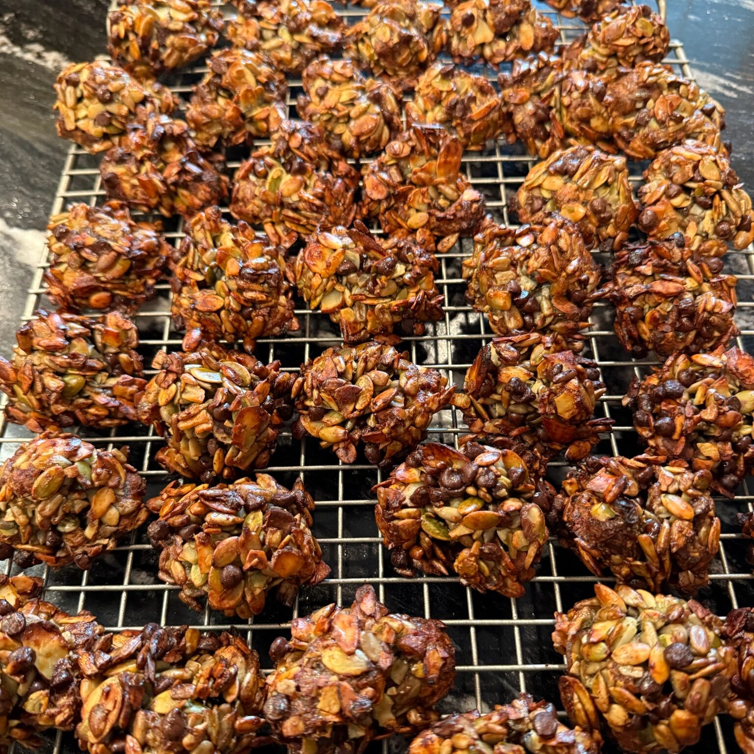 Date nut clusters sitting on a cooling rack.